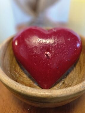 Handmade Heart-Shaped Red Candle Nestled In A Wooden Bowl